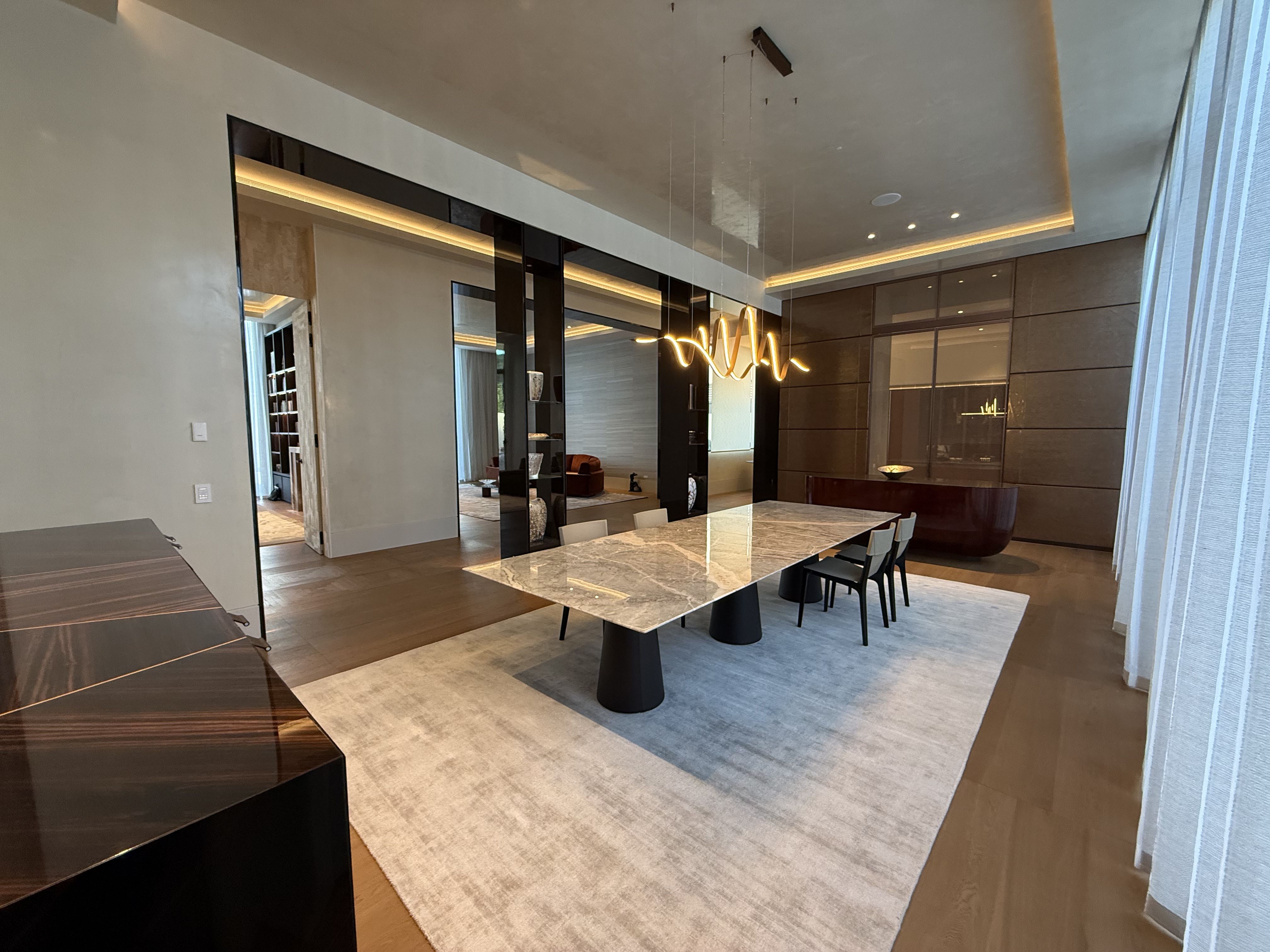 Dining room with marble table and bronze chandelier